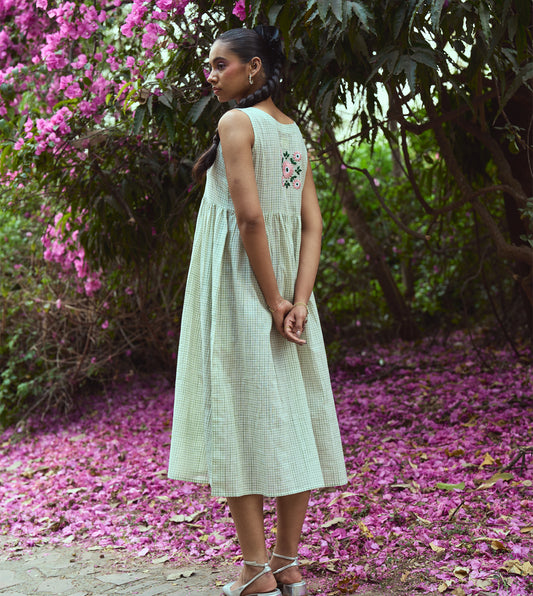 Sleeveless khadi cotton midi dress with sketchy check embroidery and hand-stitched motif, handcrafted in India.