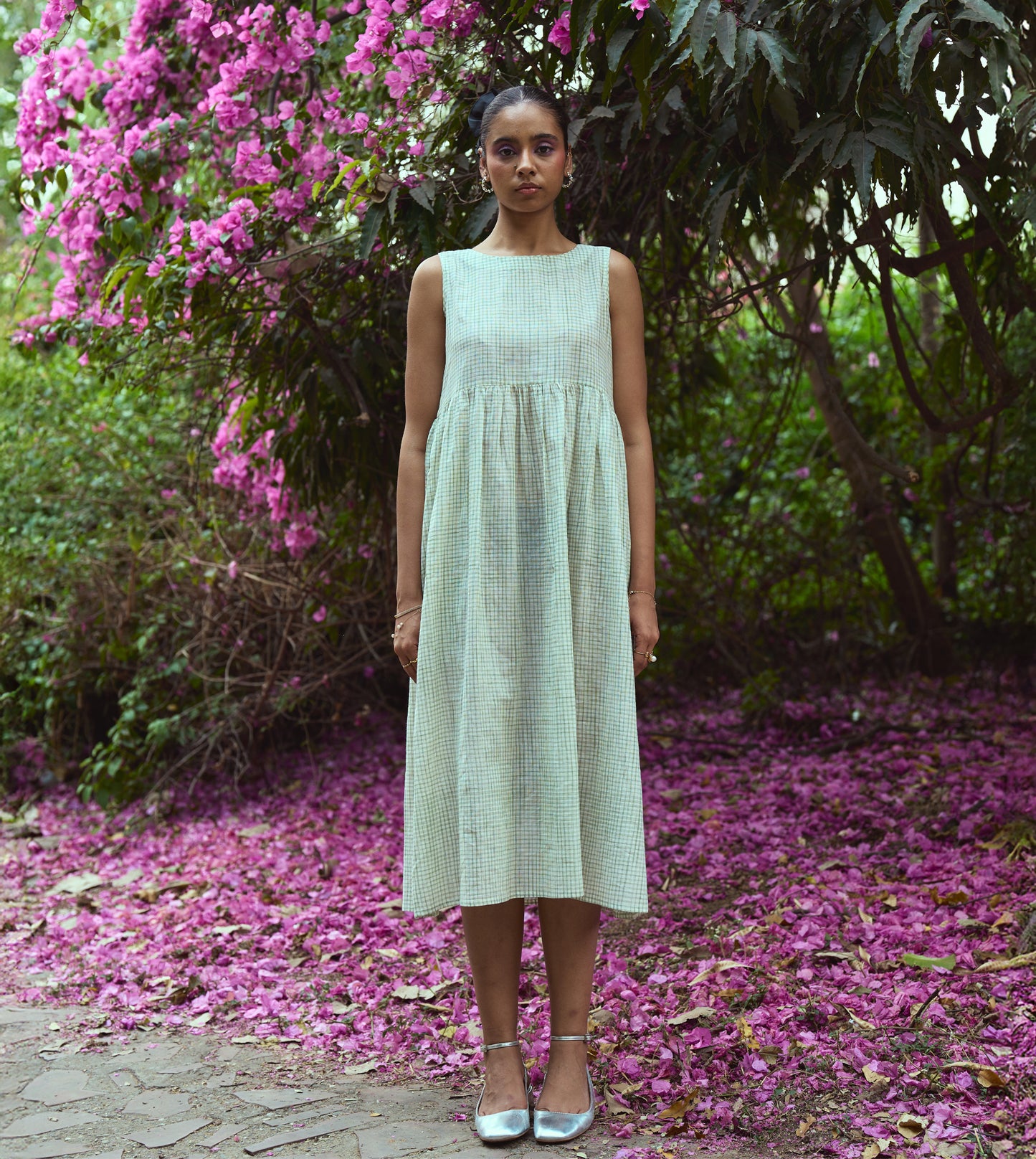 Sleeveless khadi cotton midi dress with sketchy check embroidery and hand-stitched motif, handcrafted in India.