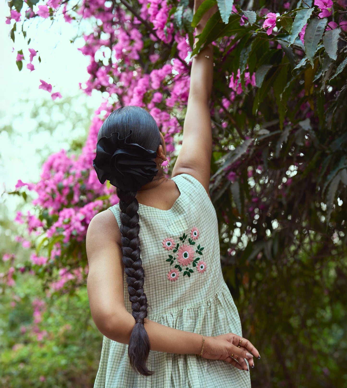 Sleeveless khadi cotton midi dress with sketchy check embroidery and hand-stitched motif, handcrafted in India.
