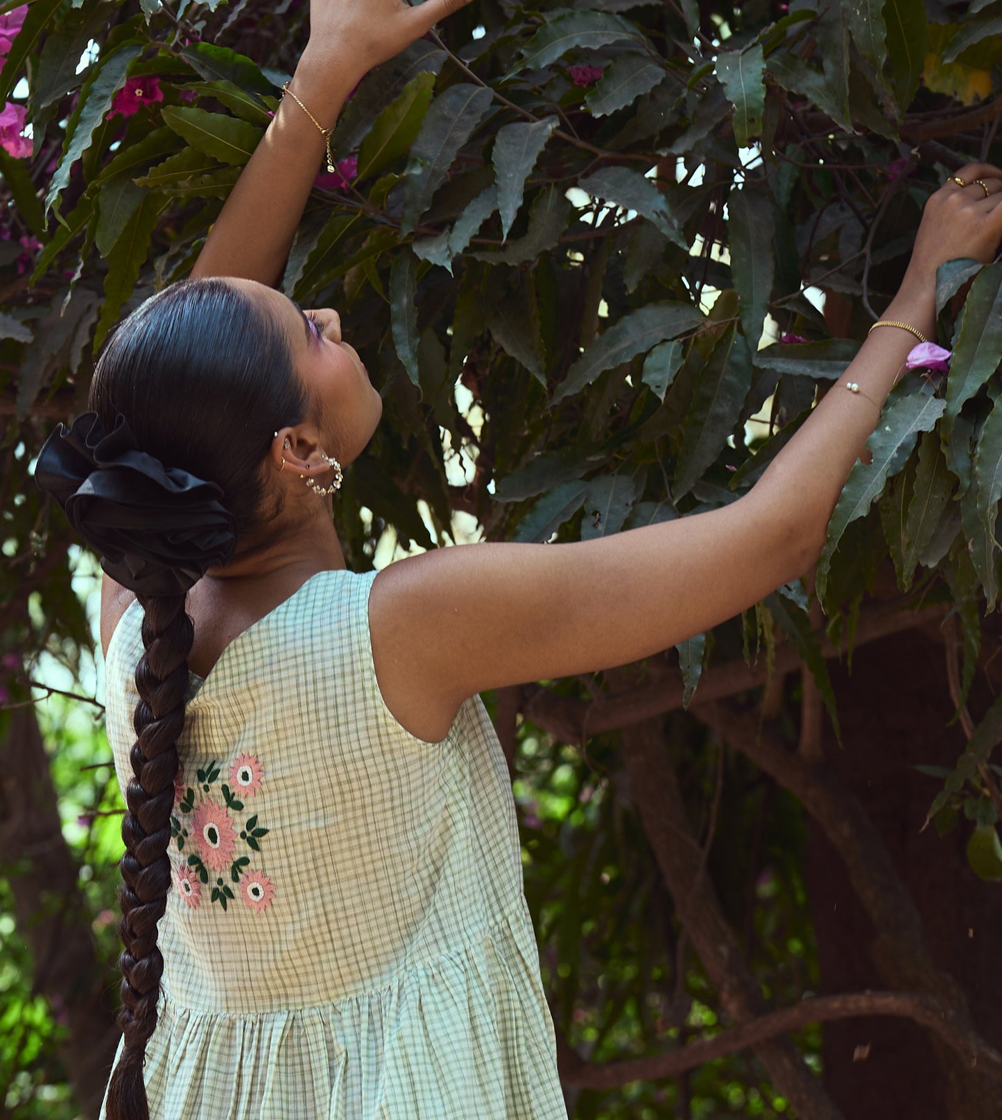 Sleeveless khadi cotton midi dress with sketchy check embroidery and hand-stitched motif, handcrafted in India.