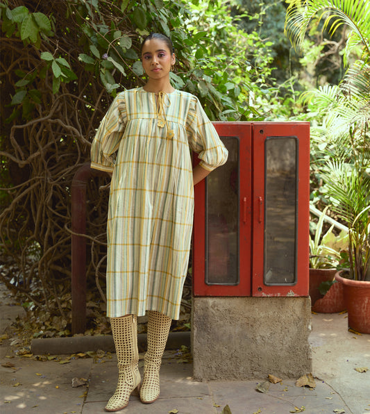 Striped khadi cotton dress with flower-tasseled ties and ¾ sleeves, offering a relaxed and elegant silhouette.