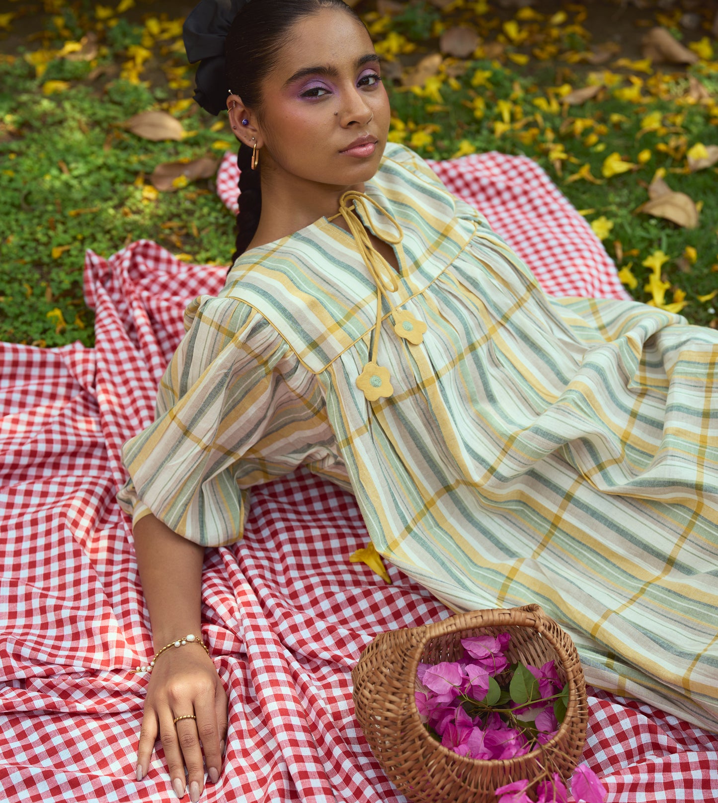 Striped khadi cotton dress with flower-tasseled ties and ¾ sleeves, offering a relaxed and elegant silhouette.