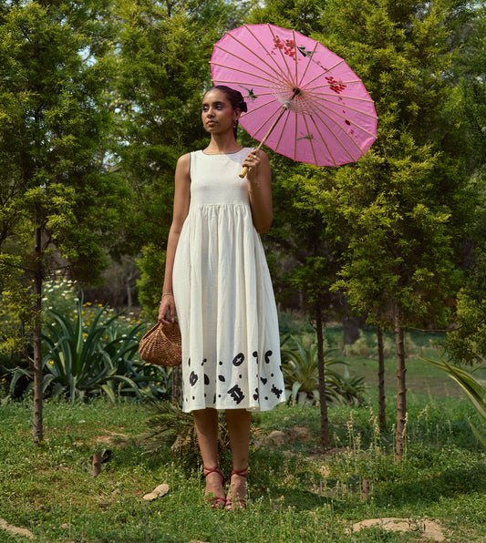 Sleeveless kala cotton midi dress with hand-stitched appliqué patterns and pockets, designed for versatile styling.