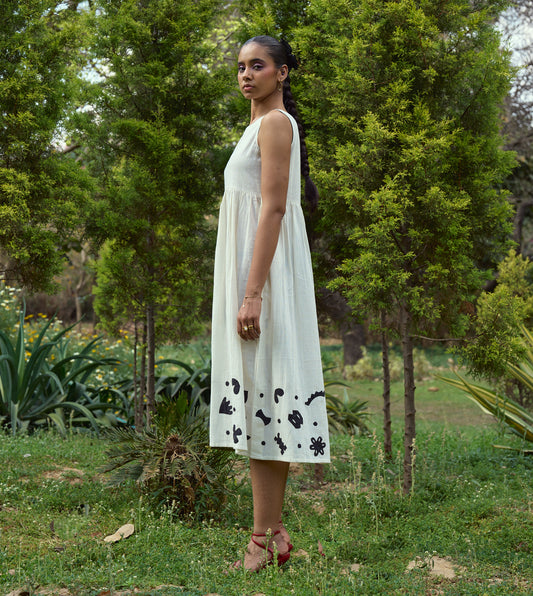 Sleeveless kala cotton midi dress with hand-stitched appliqué patterns and pockets, designed for versatile styling.