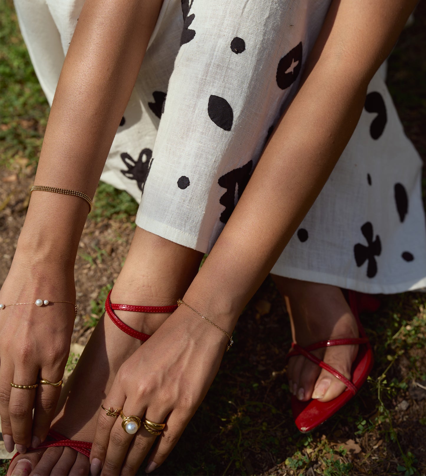 Sleeveless kala cotton midi dress with hand-stitched appliqué patterns and pockets, designed for versatile styling.