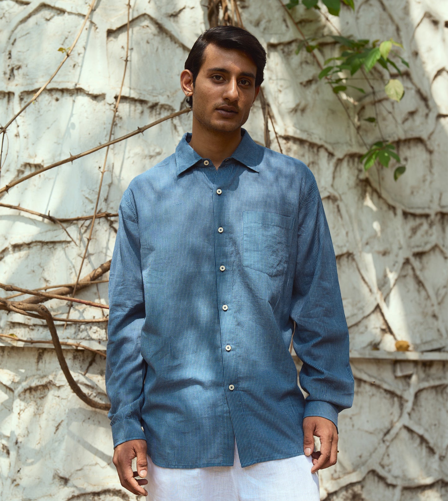 Men’s pinstriped khadi cotton full-sleeve shirt with corozo buttons, suitable for casual or formal looks.