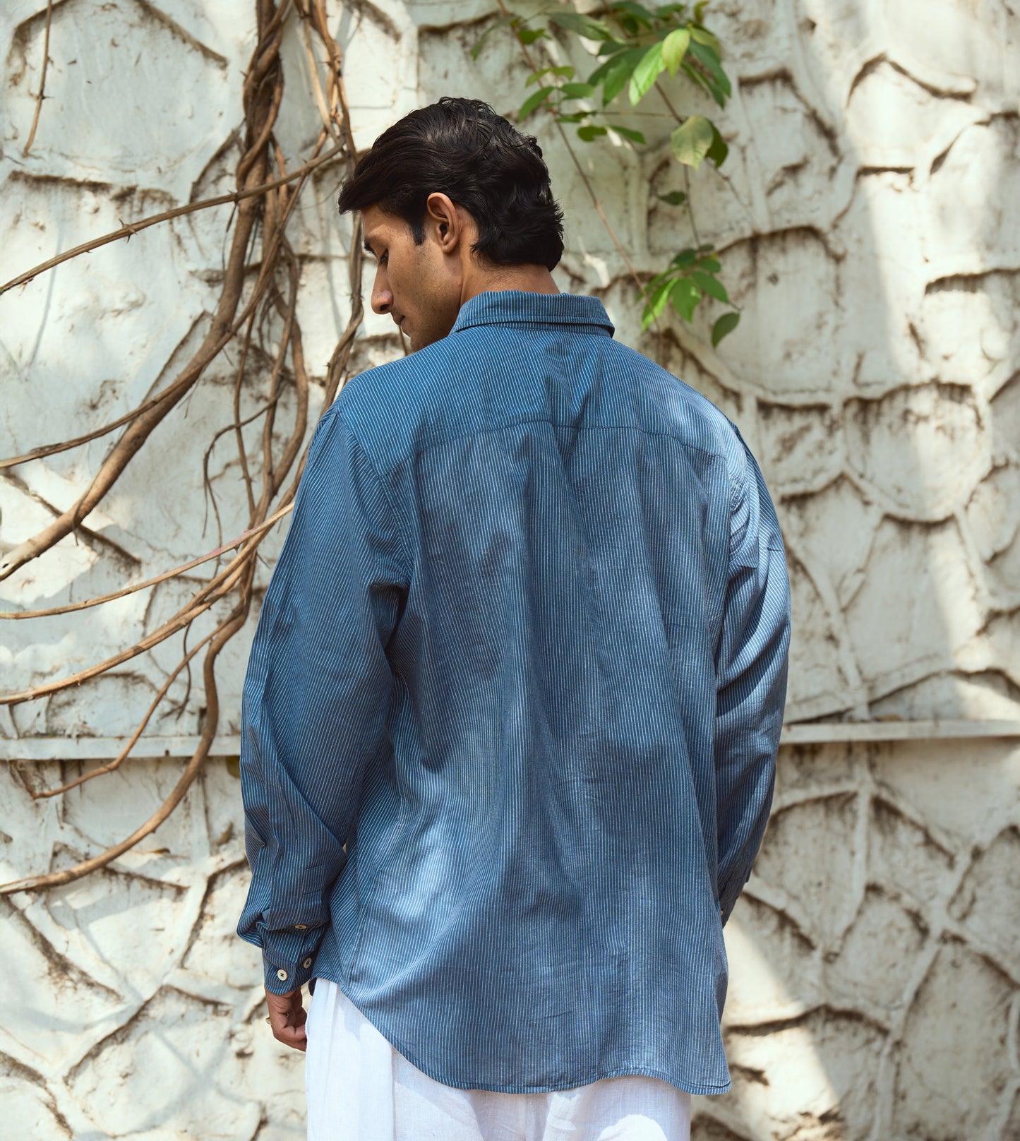 Men’s pinstriped khadi cotton full-sleeve shirt with corozo buttons, suitable for casual or formal looks.
