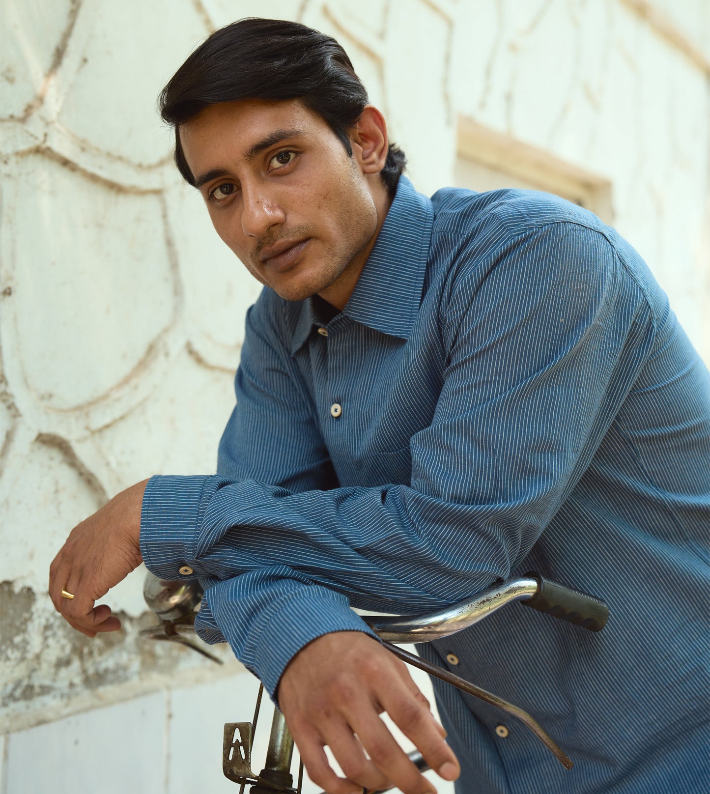 Men’s pinstriped khadi cotton full-sleeve shirt with corozo buttons, suitable for casual or formal looks.