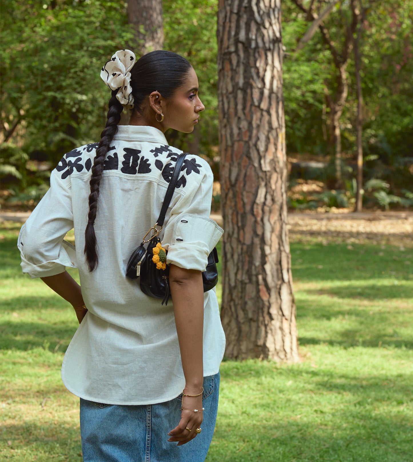 Full-sleeve kala cotton shirt with hand-stitched appliqué patterns and corozo buttons, relaxed fit.