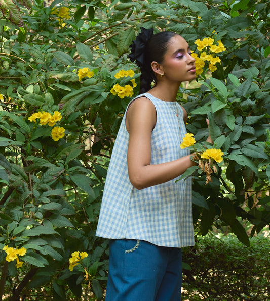 Sleeveless gingham kala cotton trapeze top with brass button closure, made from organic cotton.