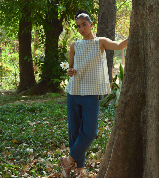 Sleeveless gingham kala cotton trapeze top with brass button closure, made from organic cotton.