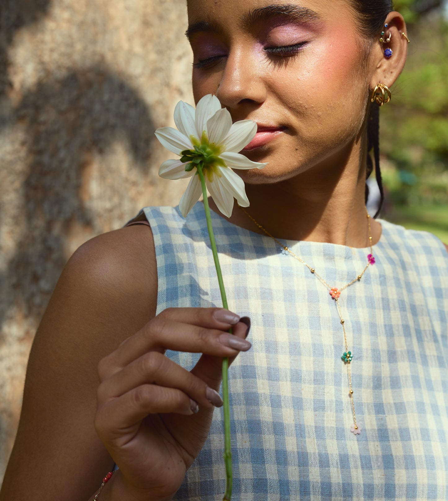 Sleeveless gingham kala cotton trapeze top with brass button closure, made from organic cotton.