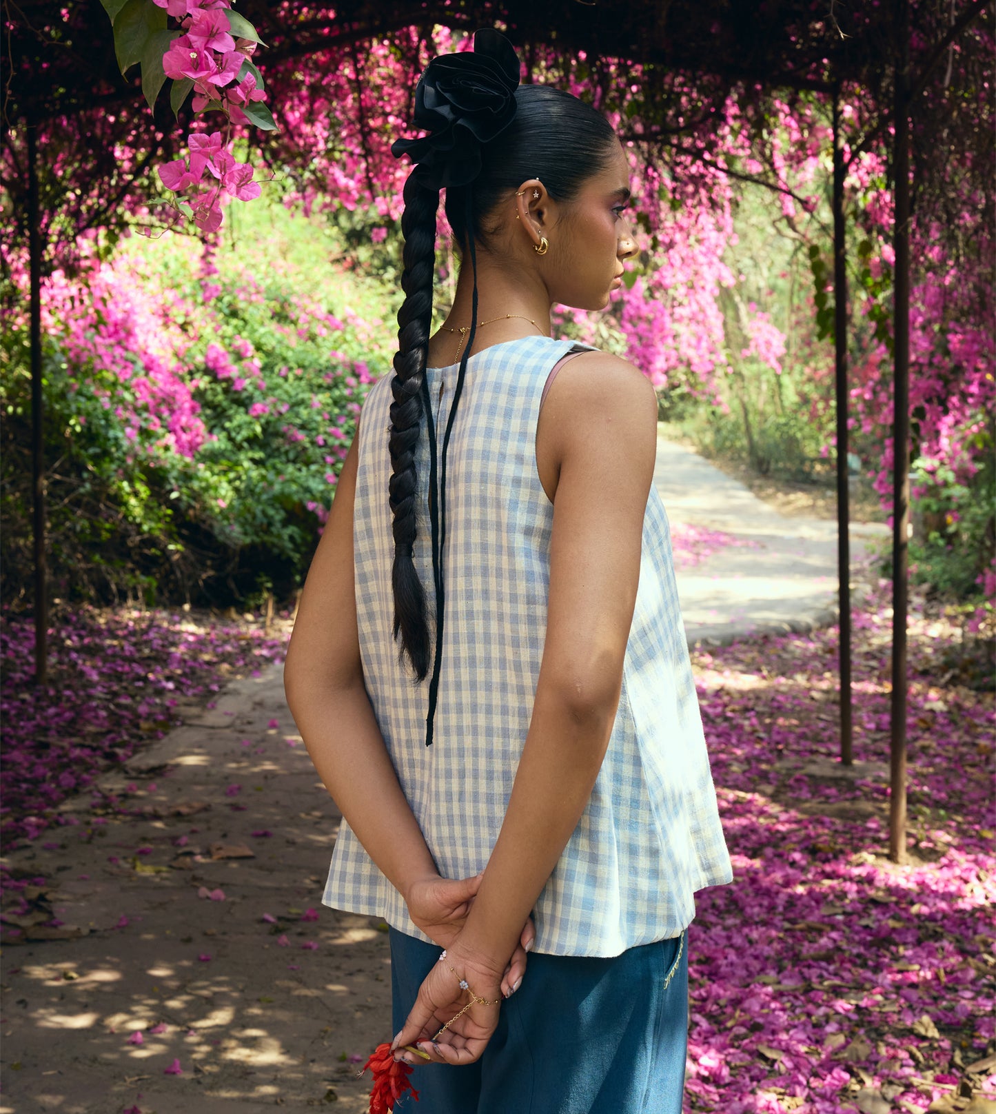 Sleeveless gingham kala cotton trapeze top with brass button closure, made from organic cotton.