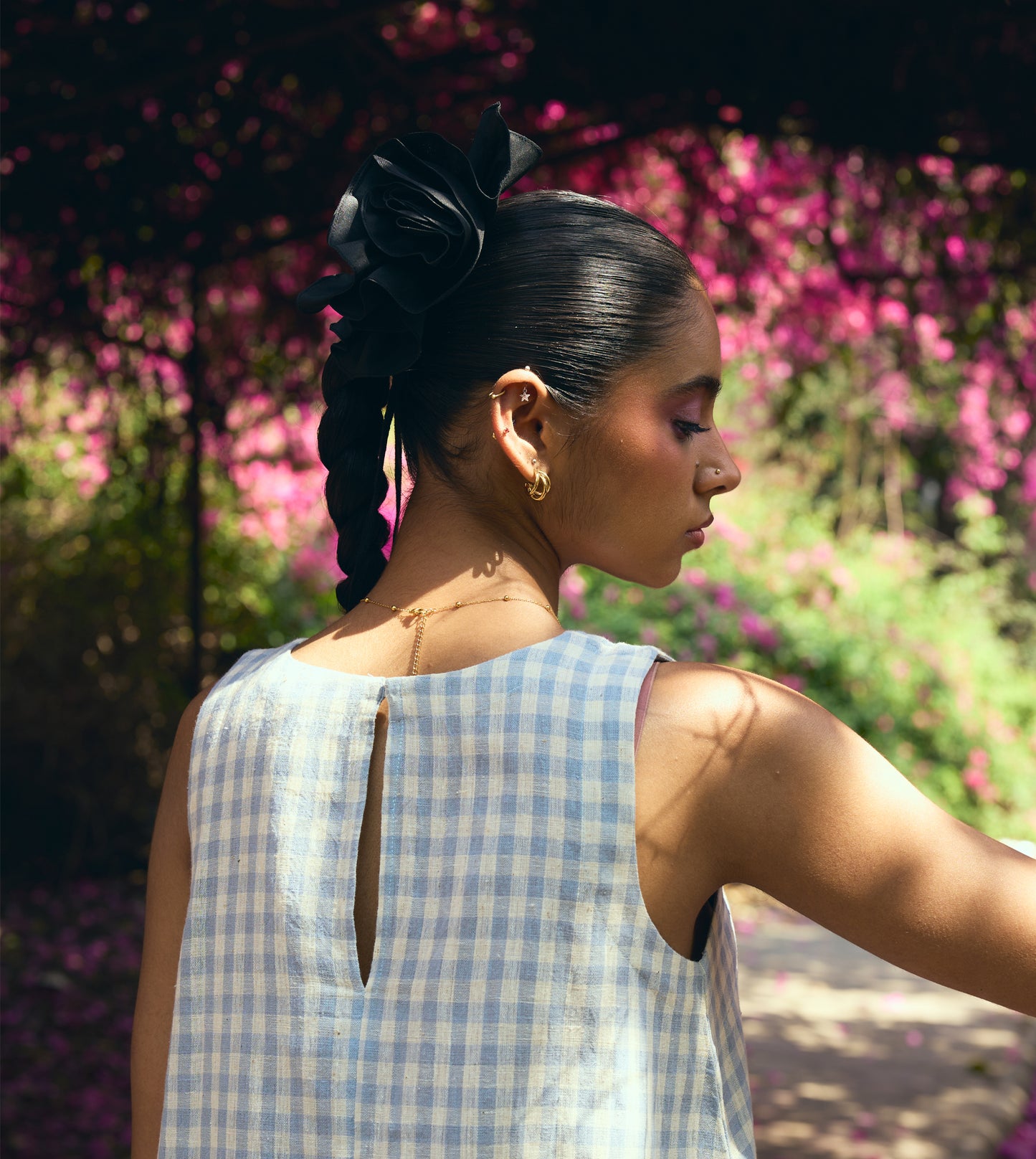 Sleeveless gingham kala cotton trapeze top with brass button closure, made from organic cotton.
