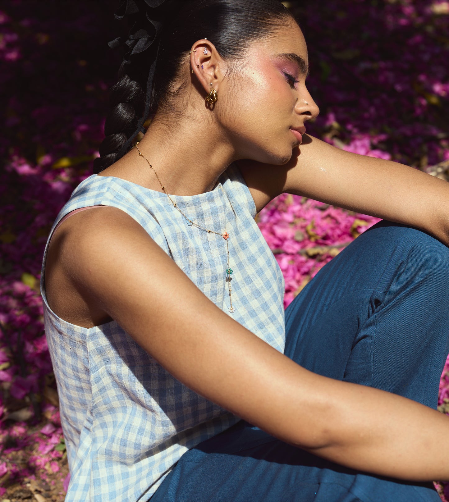 Sleeveless gingham kala cotton trapeze top with brass button closure, made from organic cotton.