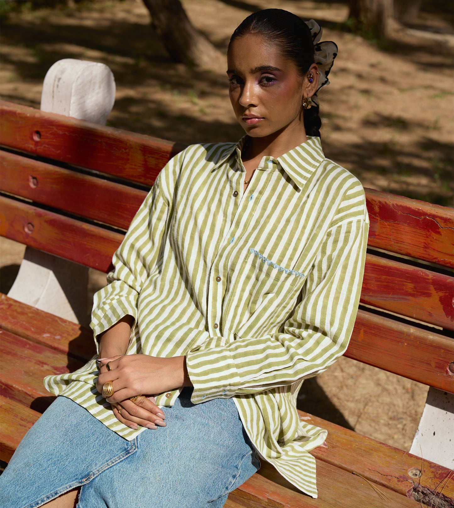 Block-printed striped kala cotton shirt with brass buttons, blue embroidery, and a relaxed fit.