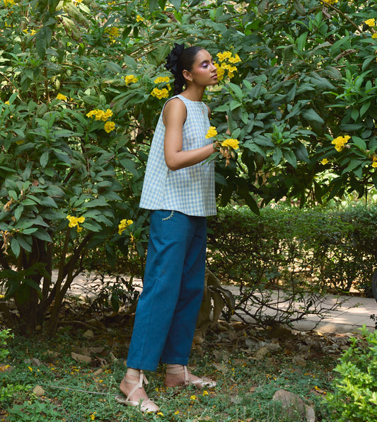 High-waisted thick cotton pants with embroidered pockets, brass button closure, and zippered fly.