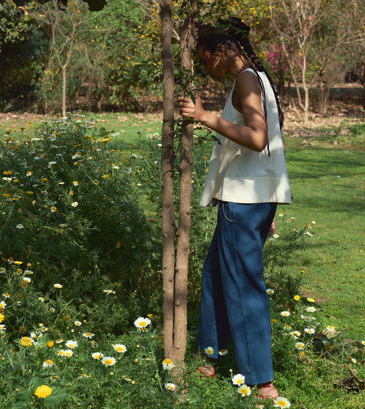 High-waisted thick cotton pants with embroidered pockets, brass button closure, and zippered fly.