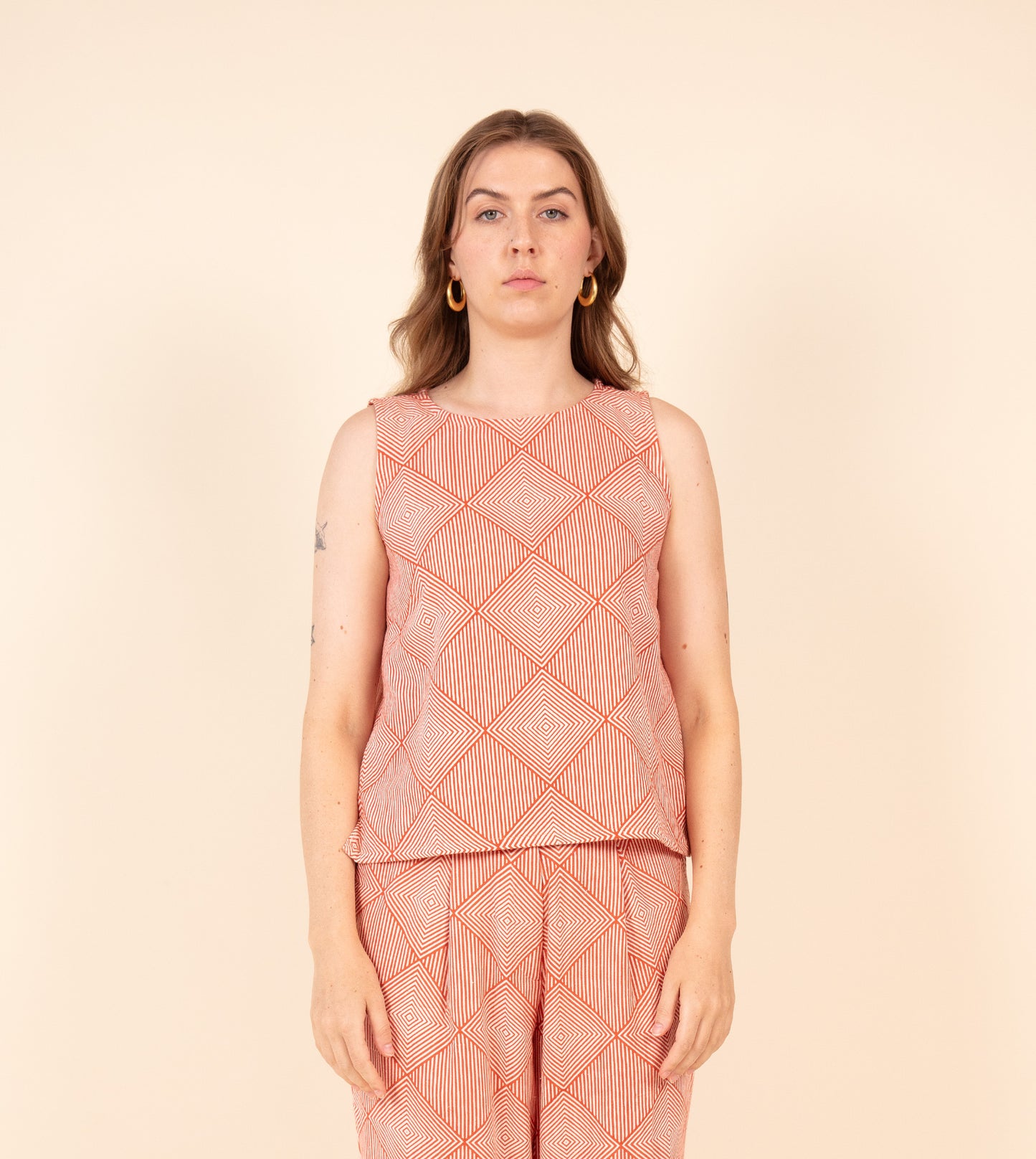 Radiate Akira Top Orange | Harkoi Studio - Elevating traditional patterns with a modern edge, the Radiate Akira, a sustainable- with precision and care. Keywords: radiate, akira, top, orange, sustainable orange, eco-friendly fashion, top.