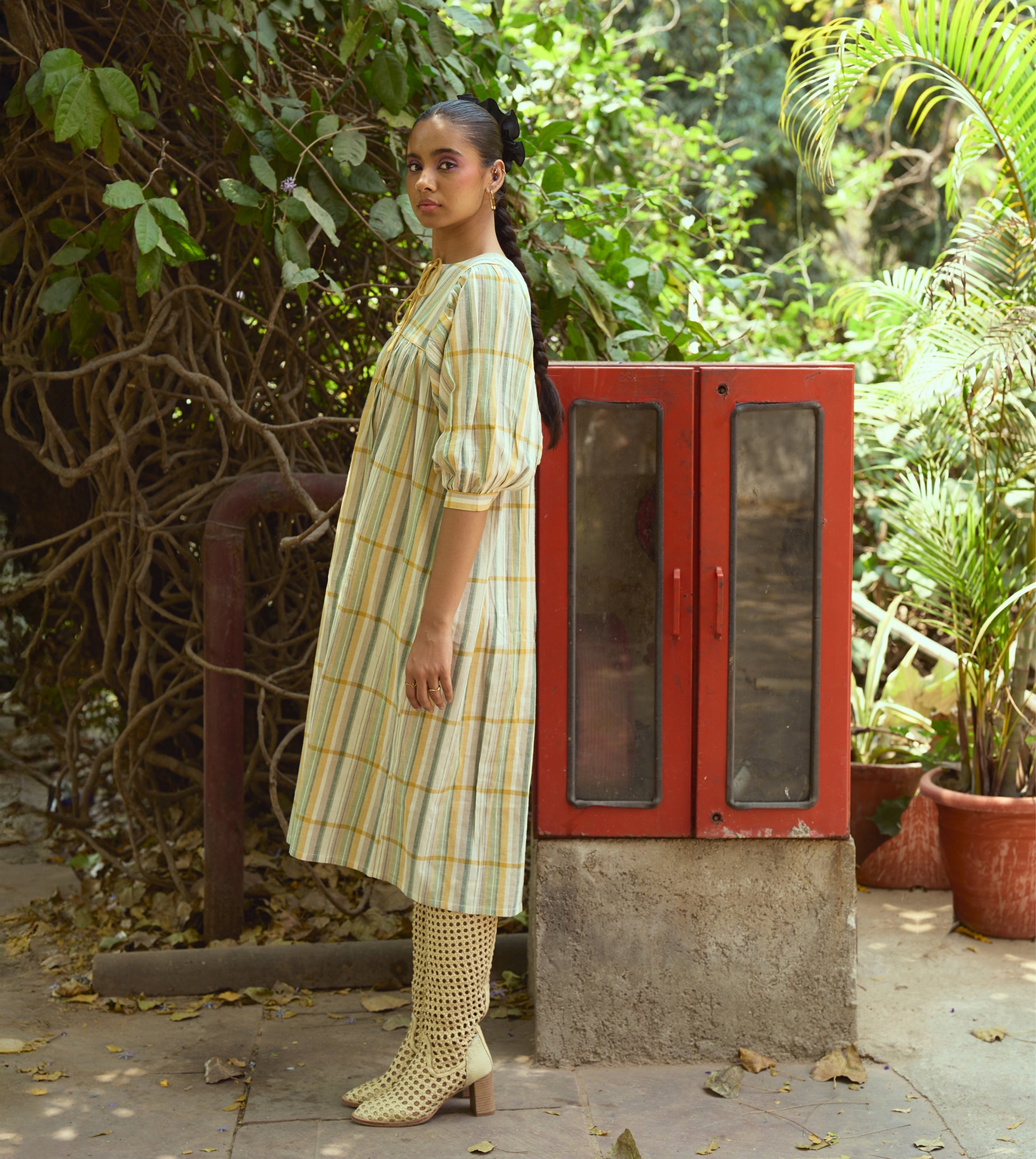 Striped khadi cotton dress with flower-tasseled ties and ¾ sleeves, offering a relaxed and elegant silhouette.