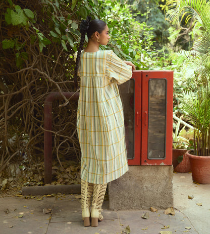 Striped khadi cotton dress with flower-tasseled ties and ¾ sleeves, offering a relaxed and elegant silhouette.