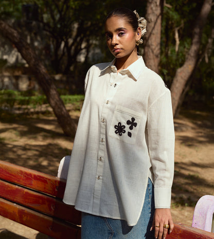 Full-sleeve kala cotton shirt with hand-stitched appliqué patterns and corozo buttons, relaxed fit.