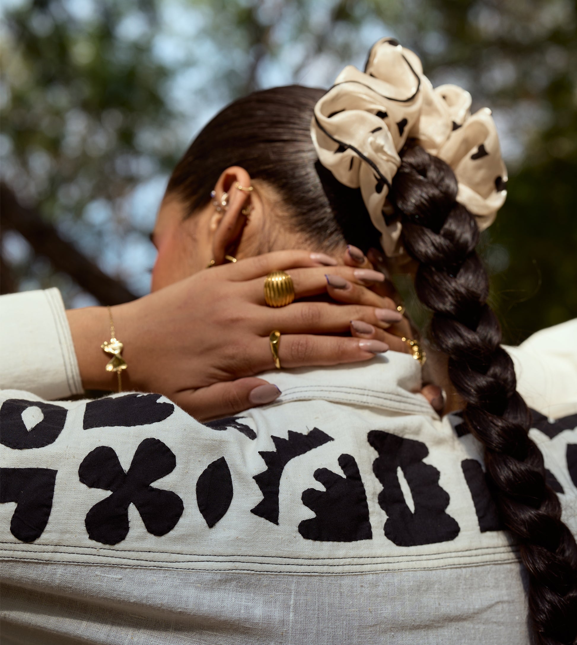 Full-sleeve kala cotton shirt with hand-stitched appliqué patterns and corozo buttons, relaxed fit.
