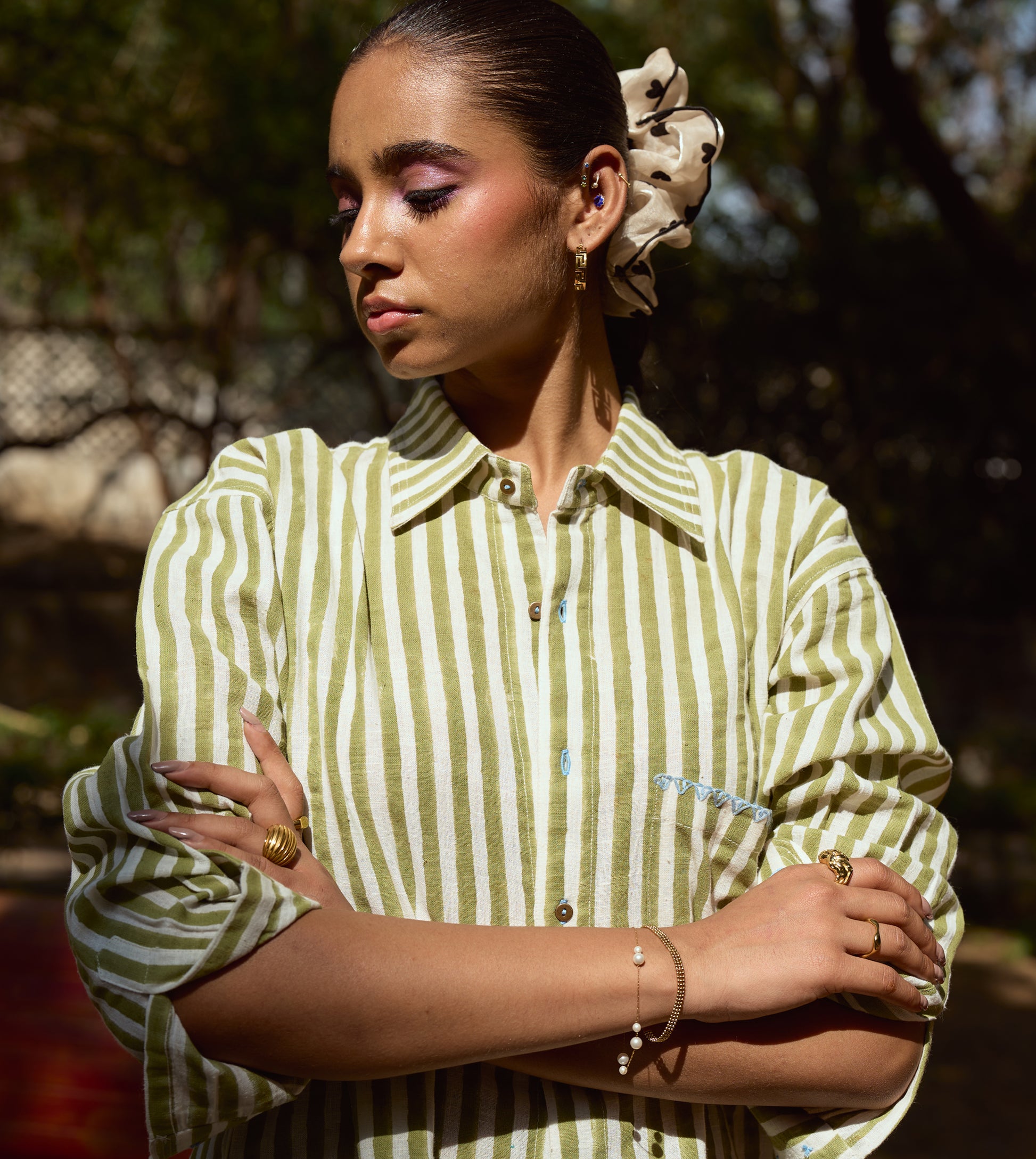 Block-printed striped kala cotton shirt with brass buttons, blue embroidery, and a relaxed fit.