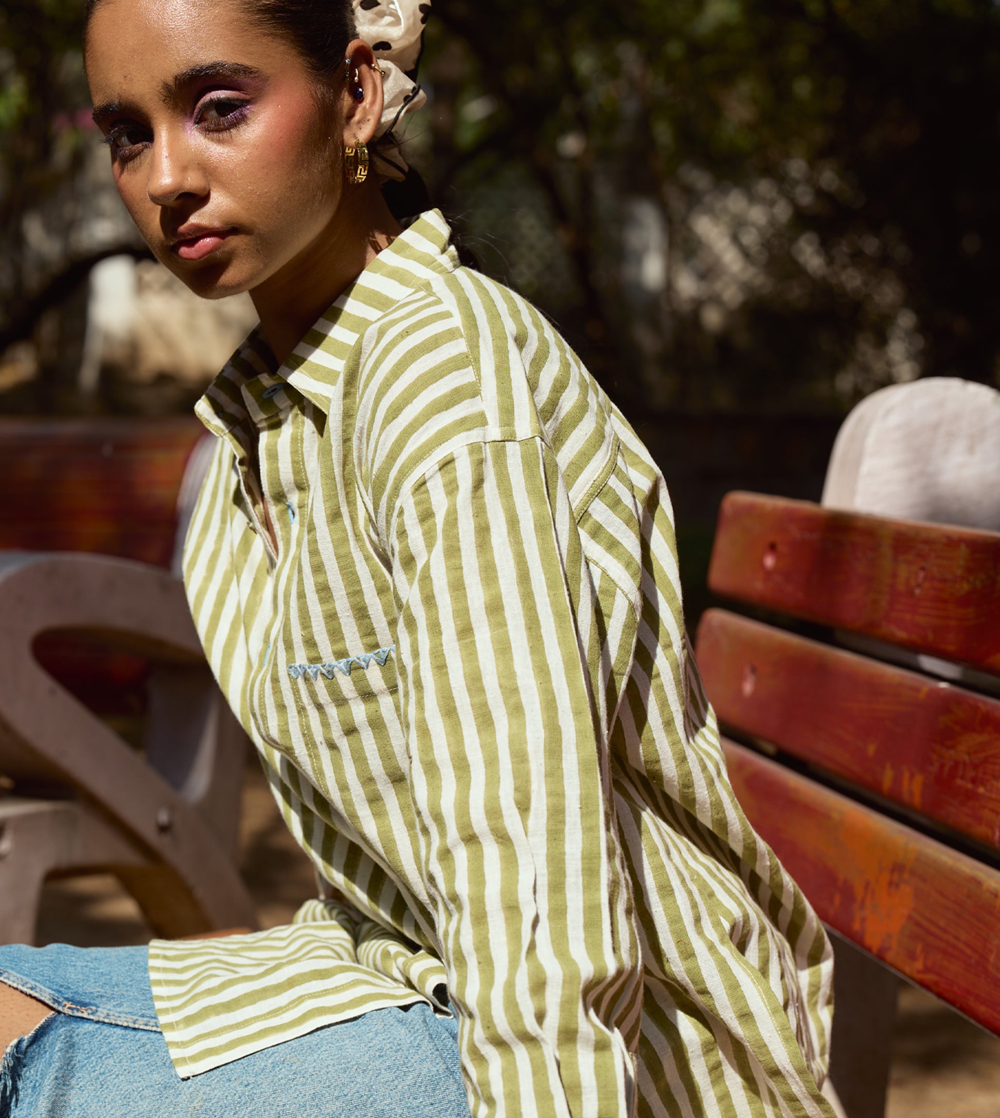 Block-printed striped kala cotton shirt with brass buttons, blue embroidery, and a relaxed fit.